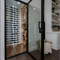 Modern wine cellar with dual-paned glass door.