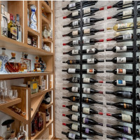 Stonework was added to style the backwall behind the modern metal wine cellar racks.