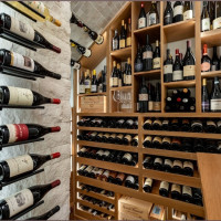 Different styles of storage compartments were incorporated into this modern wine cellar's wooden racks.